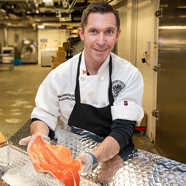 Executive Chef Michael Hinrichs holds up a fish.