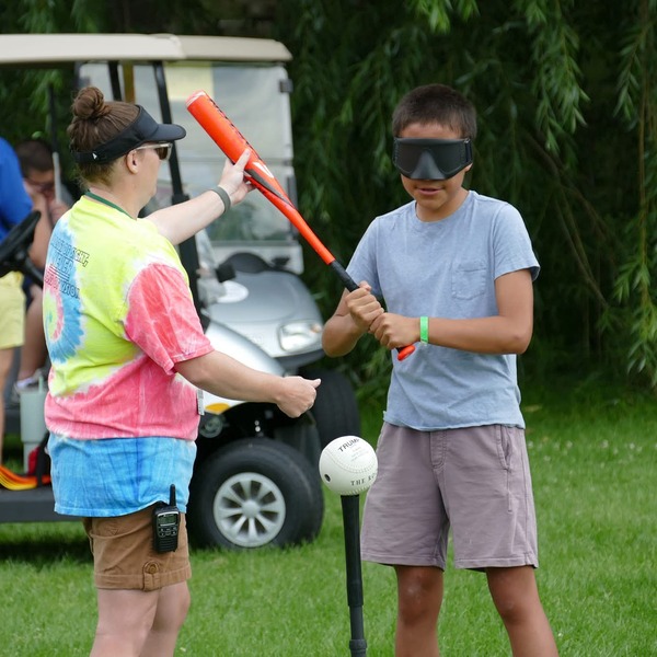 Campers play beep baseball, a modified version of the classic sport consisting of a beeping ball and buzzing bases
